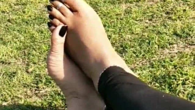 Indian desi bhabhi showing her long toenails in black nailpolish at public